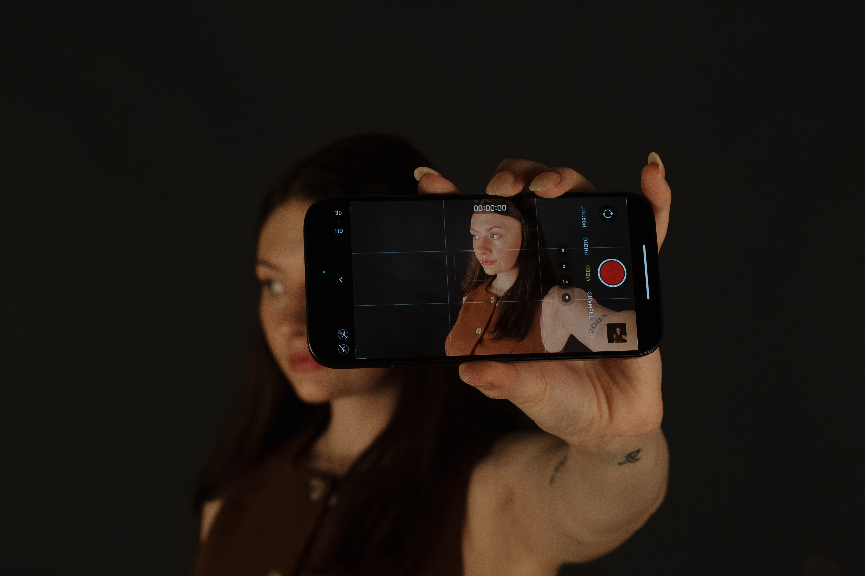 Bryanne holding an iPhone out to where you can see her in the frame of the iPhone